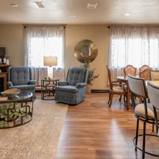 A cozy living room with comfortable seating and a dining area.