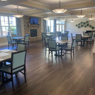 Spacious and well-lit dining area with neatly arranged tables and chairs.