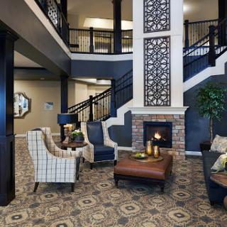 A stylish lobby featuring comfortable seating, a decorative fireplace, and a welcoming atmosphere.