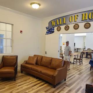 A cozy room with comfortable seating and a 'Wall of Honor' display.