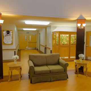 A well-lit lobby area featuring a comfortable sofa and hallway.