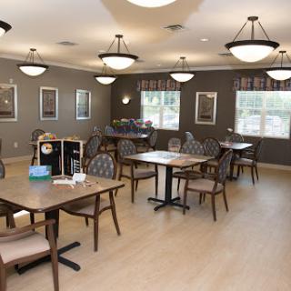 A cozy and well-lit dining room designed for communal gatherings.