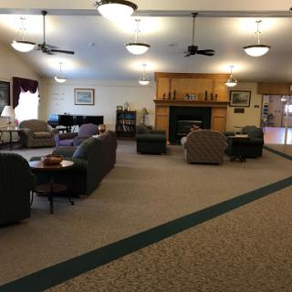 A cozy lounge area featuring comfortable seating and a warm fireplace.