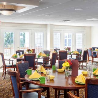 A bright and spacious dining room with tables set for a meal.