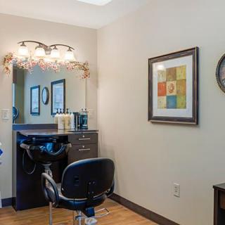 A well-organized hair salon station with stylish decor and warm lighting.