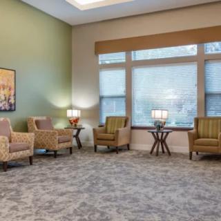A cozy waiting room with comfortable chairs and warm lighting.