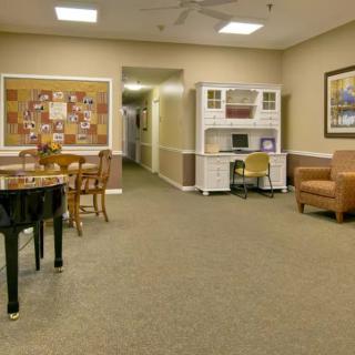 A cozy room with a piano, furniture, and warm lighting.