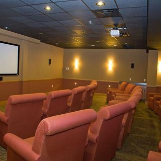 A cozy home theater with comfortable seating and a large screen.