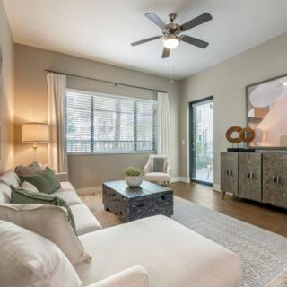 A modern living room with a comfortable sofa, stylish coffee table, and sleek wooden flooring.