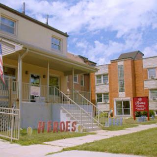 A view of a building with visible signage and an American flag in front.