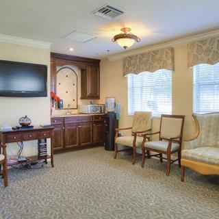 A cozy living room with comfortable seating and a mounted TV.