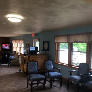 A cozy waiting room with chairs and a television.