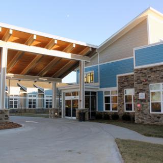 A modern building featuring a welcoming entrance and contemporary architectural elements.