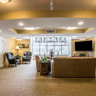 A cozy living room with comfortable seating and a large window.