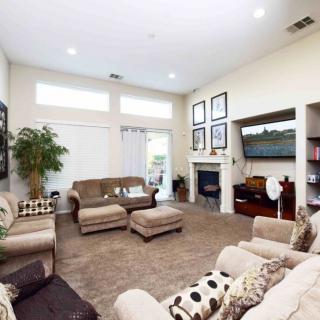 A modern living room with comfortable seating and a cozy fireplace.