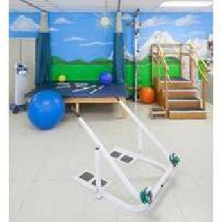 A physical therapy room equipped with parallel bars, exercise balls, and a staircase for rehabilitation exercises.
