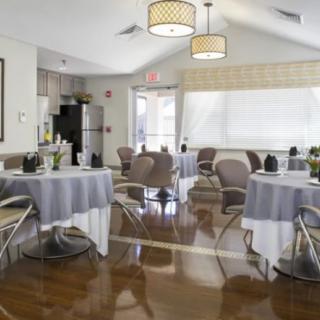 A modern dining room with elegantly set tables and comfortable chairs.