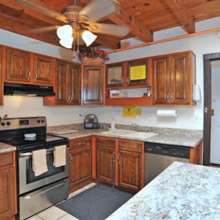 Cozy kitchen with wooden cabinetry and modern appliances.