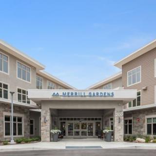 Front view of the entrance to a Merrill Gardens building with clear blue skies.