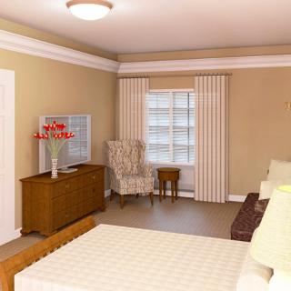 A cozy bedroom interior featuring a bed, armchair, and a dresser with decorative flowers.
