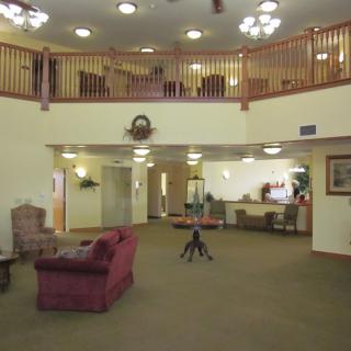 A spacious two-story lobby with seating and a reception area.