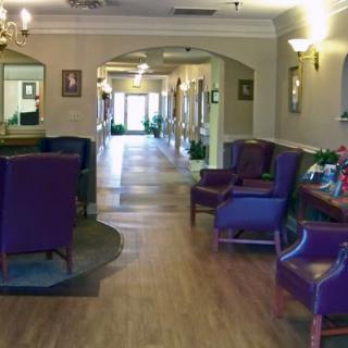 A welcoming lobby featuring purple seating and a wooden floor, designed for comfort and relaxation.