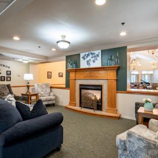 A cozy living room featuring a fireplace and comfortable seating arrangements.