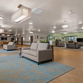 A spacious lobby with modern furniture and a comfortable seating area.