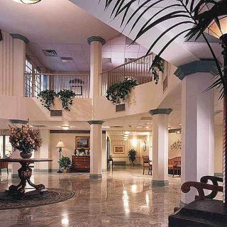 A luxurious hotel lobby with elegant columns and tasteful decor.