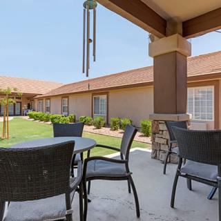 Outdoor patio area with tables and chairs in a courtyard setting.