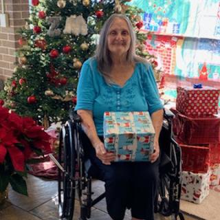 A joyful moment shared during the holiday season, surrounded by festive decorations and gifts.