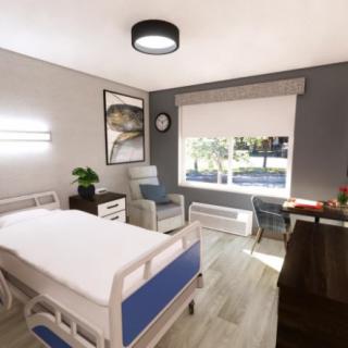 A modern hospital room with a bed, comfortable chair, and large window providing natural light.