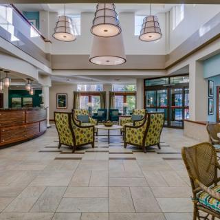A modern hotel lobby featuring comfortable seating and elegant lighting.