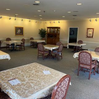 A spacious and inviting dining area with neatly set tables and comfortable chairs.