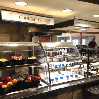 A cafeteria with various food and beverage options displayed for self-service.