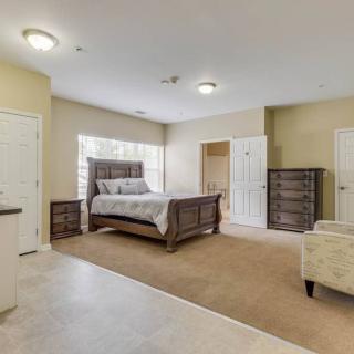 Spacious bedroom with a large bed, nightstands, and a dresser.