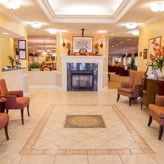 A cozy lobby area with comfortable seating and a fireplace.