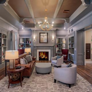 A stylish living room featuring a cozy fireplace and elegant furnishings.