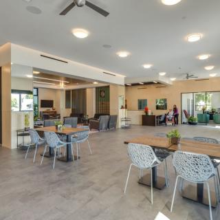 A modern and spacious interior with stylish tables and chairs, creating an inviting dining area.