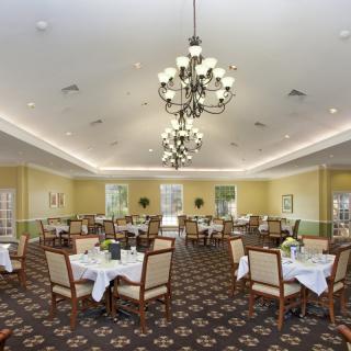 An elegant dining room with well-arranged tables and chandeliers.