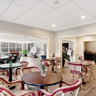 A cozy cafe interior with tables and chairs arranged for guests.