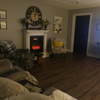 A cozy living room with a fireplace and comfortable seating.