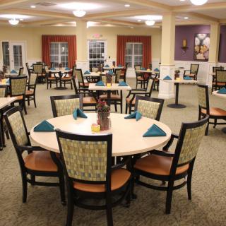 An elegantly set dining area with neatly arranged tables and chairs.