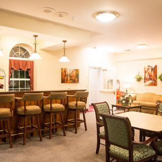 A cozy dining area with a bar and seating arrangements.