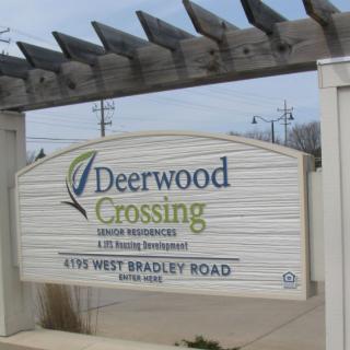 A sign for Deerwood Crossing senior residences and housing development.