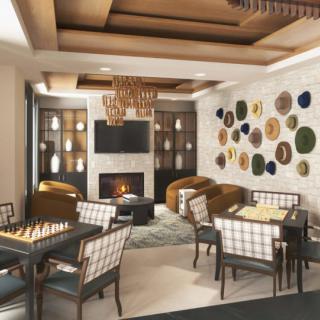 A modern living room featuring a cozy fireplace, elegant chandeliers, and stylish wall art.