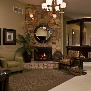 A cozy living room with a stone fireplace and elegant decor.