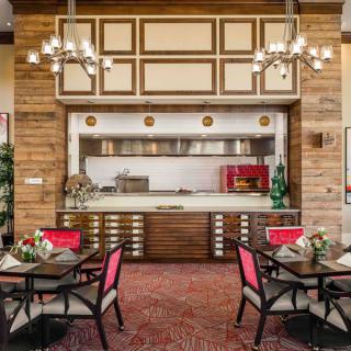 A luxurious restaurant interior featuring wooden paneling, elegant chandeliers, and a cozy dining area.