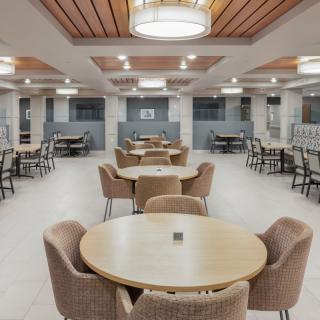 A modern restaurant interior with neatly arranged tables and chairs.