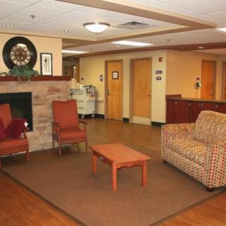 A cozy lobby area with seating and a fireplace.